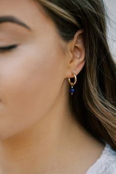 Trendy everyday hoops with a pop of color. These dainty hoop earrings feature a genuine lapis lazuli stone. Lapis lazuli is a deep blue semi-precious stone considered the universal symbol of wisdom and truth. These hoop earrings are available in your choice of 14k gold filled or sterling silver. The hoops have an easy to open and close latch top. The total drop on these earrings is about 1 inch. Your new earrings will arrive in a complimentary gift box. To see other jewelry from Austin Down to E Blue Huggie Earrings For Everyday, Blue Small Hoop Earrings With Matching Set, Blue Huggie Single Earring, Elegant Blue Huggie Earrings For Everyday Wear, Dainty Blue Hypoallergenic Hoop Earrings, Blue Dainty Hypoallergenic Hoop Earrings, Everyday Blue Teardrop Hoop Earrings, Elegant Blue Hoop Earrings For Everyday, Dainty Blue Hoop Earrings