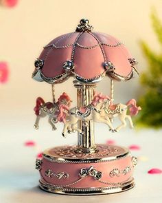 a pink carousel is sitting on a table