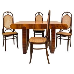 a dining table with four chairs and one chair is shown in front of the table