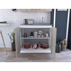 an open cabinet with pots and pans on it