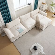 a living room with a large white sectional couch