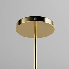 an image of a modern light fixture in gold and black color with dim lighting on the side