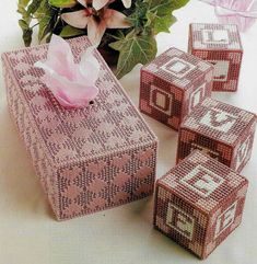 a pink box with white letters and numbers on it sitting next to some dice blocks