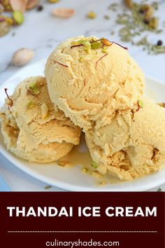 two scoops of vanilla ice cream on a white plate with pistachio seeds