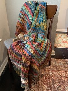 a chair with a multicolored blanket on it