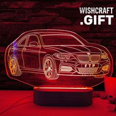 an illuminated bmw car on display with the words wishcraftt gift written below it