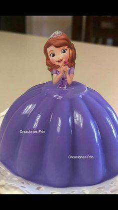 there is a purple cake with a princess on top