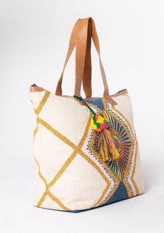 A bag worthy of a vacation! This bohemian oversize weekender bag features a colorful embroidered sunburst detail and suede leather trim. The large carry-all size is perfect for weekend getaways. Embroidered Stitch details Oversize tassel accent Zip-top closure Back exterior zip pocket Leather strap handles Bohemian weekender bag Dimensions: 24" X 17 3/4"Style: DR-8369 Bohemian Canvas Tote Shoulder Bag, Bohemian Tote Bucket Bag For Travel, Bohemian Bucket Bag Tote For Travel, Bohemian Canvas Bag With Large Capacity For Travel, Embroidered Bucket Shoulder Bag For Travel, Bohemian Beach Bag With Leather Handles For Travel, Embroidered Tote Bag For Travel, Bohemian Travel Tote Bucket Bag, Bohemian Canvas Travel Bag With Large Capacity