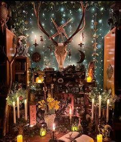 a room decorated with candles, deer head and other decorations