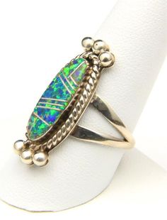 - Beautiful vintage inlay sterling silver and opal ring in size 10- Ring is signed "Sterling, M" likely for Navajo artisan Lennie Mariano- Ring face measures 1.23" tall by .45" wide and .17" deep- Ring weighs 7 grams Vintage Silver Multi-stone Opal Ring, Unique Polished Opal Ring For Collectors, Artisan Sterling Silver Oval Opal Ring, Artisan Silver Opal Ring With Multi-stone, Artisan Oval Opal Ring In Sterling Silver, Silver Opal Ring With Inlay For Anniversary, Anniversary Silver Opal Ring With Inlay, Unique Sterling Silver Opal Inlay Ring, Unique Sterling Silver Opal Ring With Inlay