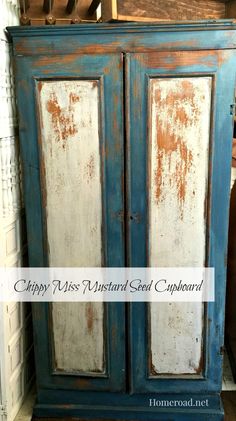 an old blue armoire with white paint and rust on the doors is shown in this image