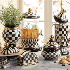 black and white checkered pots with plants in them