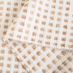 the fabric is made up of brown and white squares