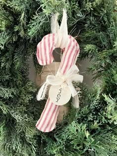 a christmas wreath with the word joy hanging on it