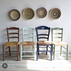 four chairs are lined up against the wall