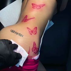 a woman's arm with butterflies on it and the word tattoo written in black ink