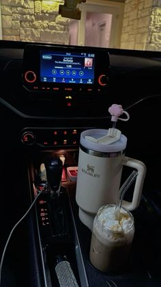 a car dashboard with a coffee cup and an appliance