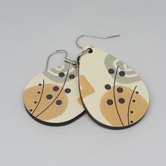 A beautiful pair of wooden sublimated teardrop earrings with a lovely abstract boho design. This design is suitable to wear all year round. The earrings have been printed on both the front and back sides.  The design is durable and the earrings are light to wear.  A great accessory have throughout the year or to give as a gift for that special someone.  The colours displayed on a computer screen may vary slightly compared to the real product. While I will endeavour to always have your items ship Real Earrings, Double Sided Earrings, Pumpkin Earrings, Boho Design, Fall Earrings, Paper Jewelry, Boho Designs, Antique Earrings, Circle Design