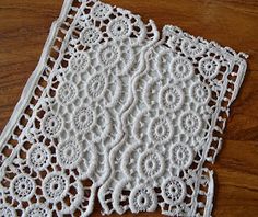 two white doily sitting on top of a wooden table