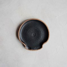 a black bowl sitting on top of a white table