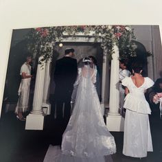 an old photo of a bride and groom standing in front of the alter at their wedding ceremony