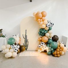 an arch made out of balloons and other decorations