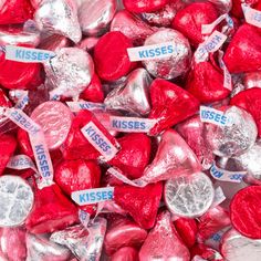 valentine's day candy hearts with kisses for sale on the side in a pile