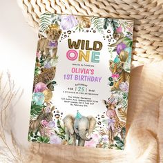 a wild one birthday party with an elephant, giraffe and zebra on it