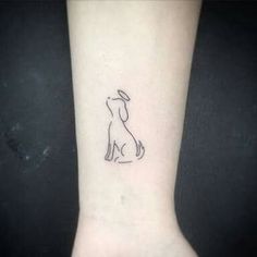 a small dog tattoo on the wrist