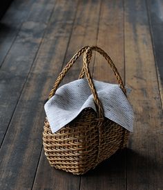 a wicker basket sitting on top of a wooden floor