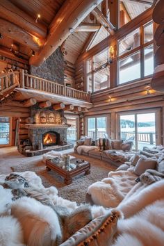 a living room filled with lots of furniture and a fire place in the middle of it