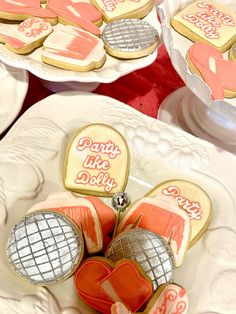 some cookies are sitting on plates with hearts