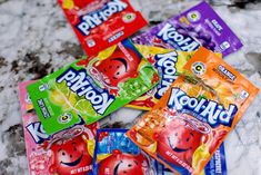 four packets of kool - aid are sitting on the ground