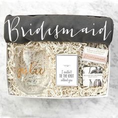 the bridesmaid gift box includes a wine glass, note cards, and more