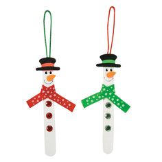 two snowmen with hats and scarfs hanging from strings