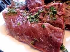 some meat is sitting on a plate with broccoli