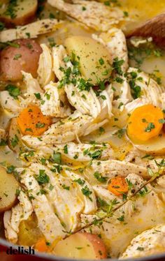 chicken and potato soup in a pot with a wooden spoon