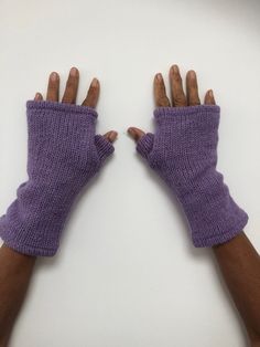 Lilac plain colour to brighten up the day these are made from knitted wool on the outside and a soft fleece lining on the inside. Warm and woolly but certainly not itchy! These lined wrist warmers are perfect for keeping your hands warm while keeping your fingers free to use a phone or find the change in your pocket! Responsibly handmade in Nepal using 100% wool. Machine washable at 30oC or below. Do not tumble dry. One size fits all - approximate length is 24cm (this may vary slightly from pair Winter Knitting Pattern In Purple, Winter Knitting Pattern In Purple Knit Fabrication, Winter Purple Knitting Pattern, Purple Gloves Aesthetic, Knit Fingerless Gloves Aesthetic, Pink Knitted Gloves, Fingerless Gloves Purple, Crochet Wrist Warmers Pink, Purple Hands