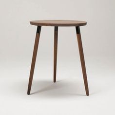 a small wooden table sitting on top of a white floor