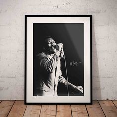 a black and white photo of a man singing into a microphone