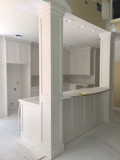 an empty kitchen with white cabinets and counter tops in the process of remodeling