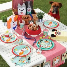 a table set for two with plates, cups and napkins on top of it