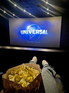 a person is sitting in front of a large screen with the words universal on it