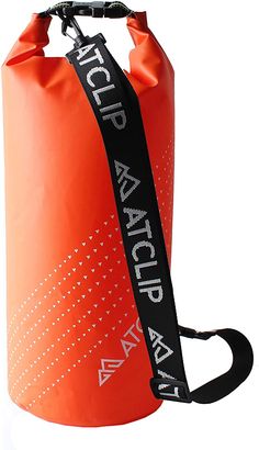 an orange water bag with black straps and white lettering on the side, sitting upright