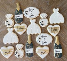 decorated cookies in the shape of bride and groom's dresses, champagne bottles, and hearts