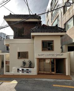 a small coffee shop on the corner of a street