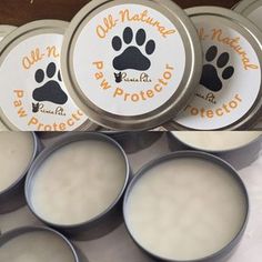 several tins with paw prints on them sitting next to each other