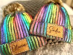 two knit hats with name tags on them