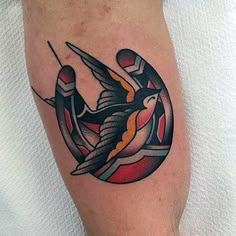 a tattoo on the leg of a person with a bird flying over it's head