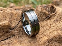 a close up of a ring on top of a tree trunk with grass in the background